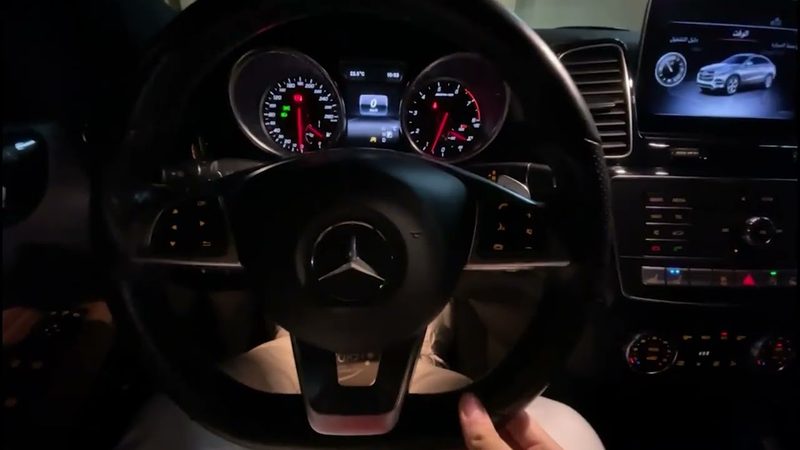 The steering wheel and lit instrument cluster of a 2019 Mercedes-Benz GLE 43 AMG at night.