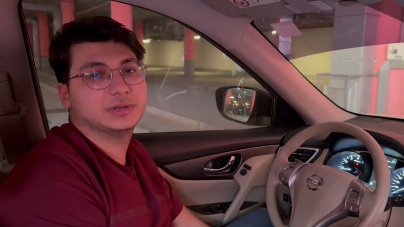 Amer talking to the camera from the driver's seat of a 2015 Nissan X-Trail.